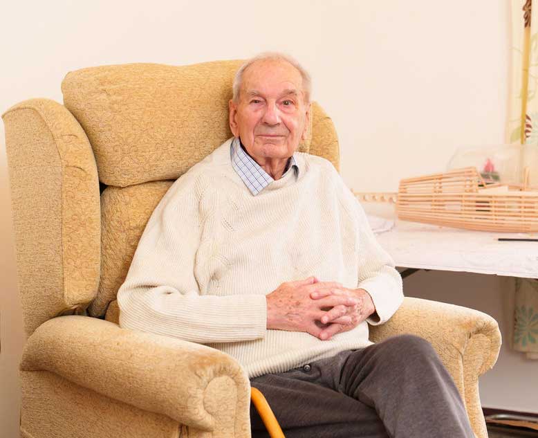 Relaxed Resident Setting in Cream Armchair